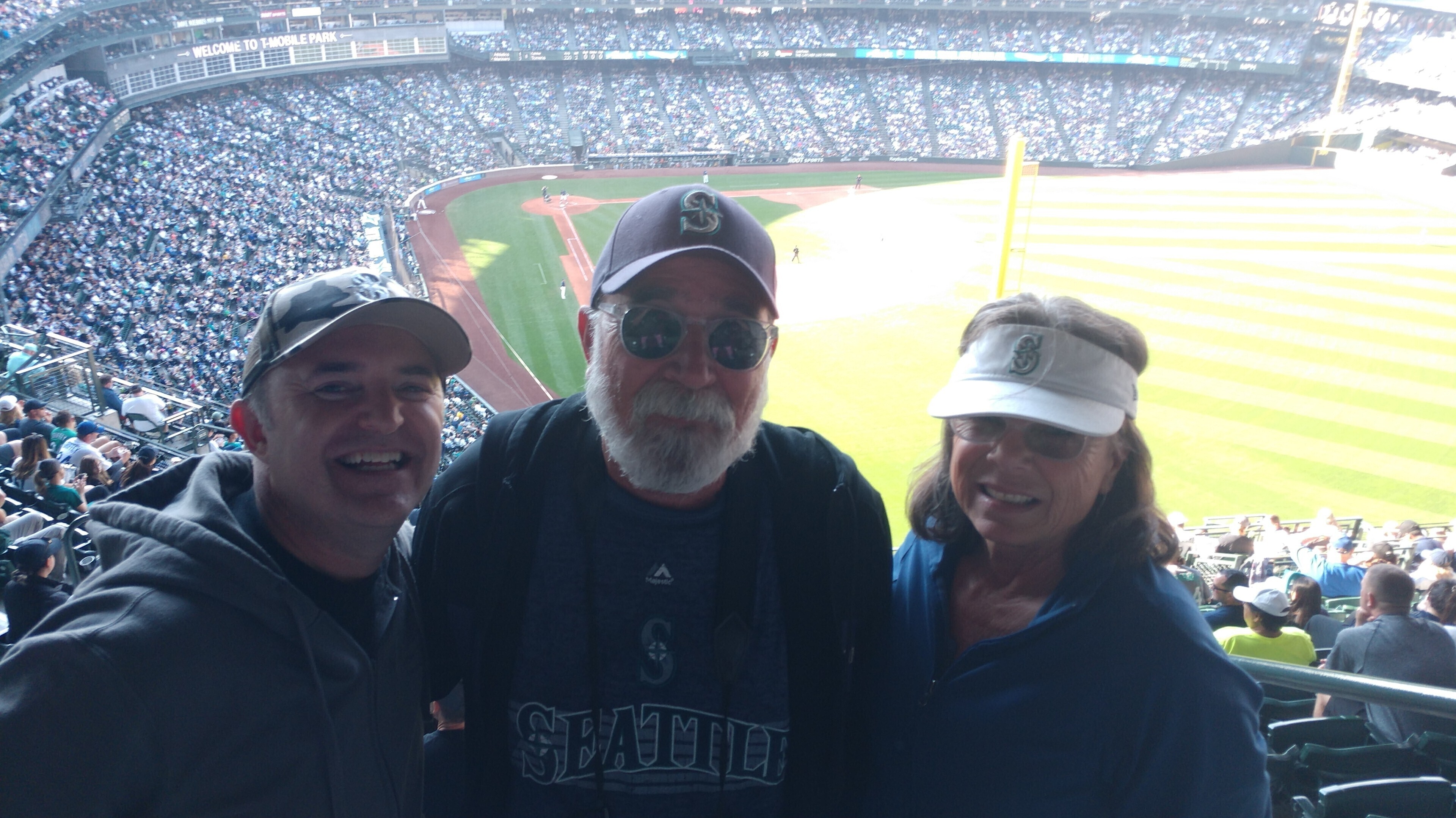 A fan wearing a Seattle Mariners jacket holds a Playoff bound