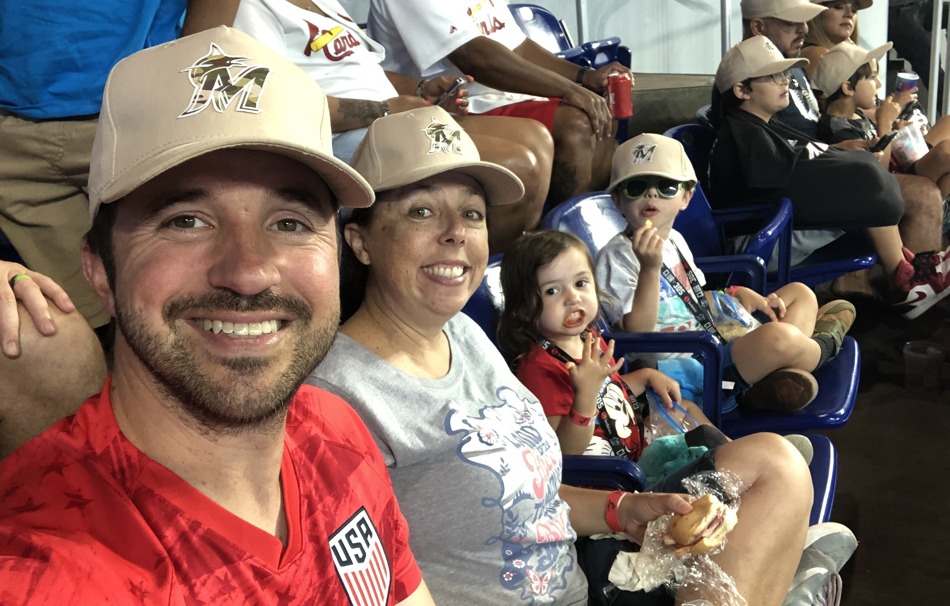 Baseball fans stand during the singing of the National Anthem before the  start of a baseball game between the Miami Marlins and the St. Louis  Cardinals, Wednesday, June 12, 2019, in Miami. (